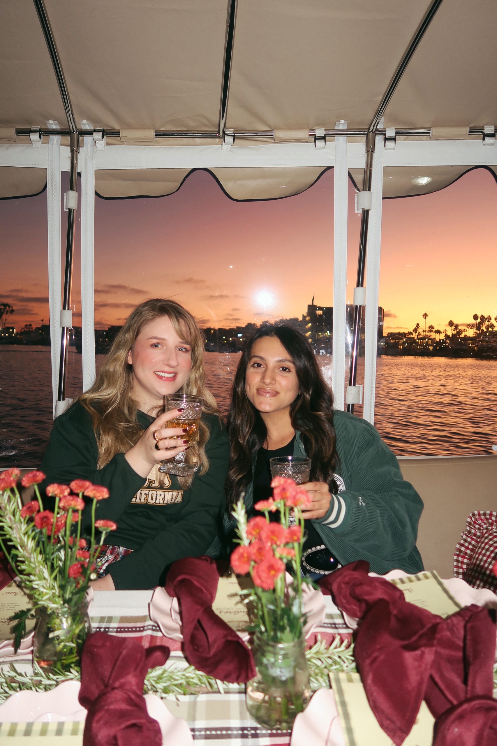 girls in duffy boat sunset